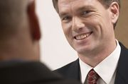 A man smiles in confidence because he received the best interview answers